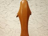 a sculpture of a dolphin on a pedestal on a table