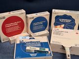 several boxes of electronic devices are sitting on a blue surface