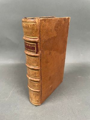 an old book sitting on top of a table next to a gray background