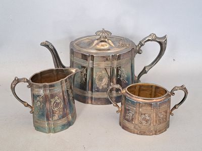 trois tasses et une théière posées sur une table