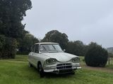a car that is parked in the grass in the field