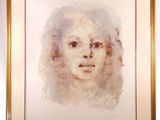 painting of a woman ' s face in a gold frame on a easel