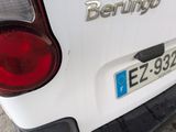 the rear end of a white car with the word berlin written on it