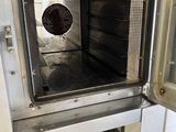 an open oven that is sitting in the kitchen