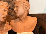 two busts of men on display in a room