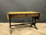 an antique writing table with two drawers and a yellow top