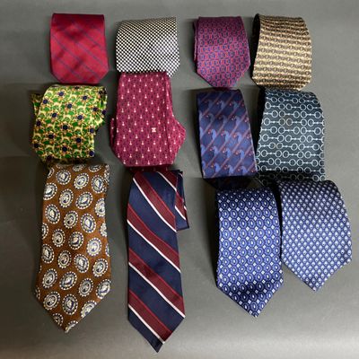 several different colored ties laid out in a row on a table