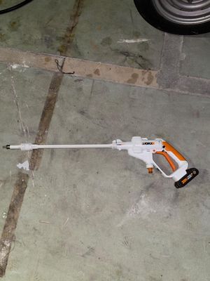 a toy gun on the ground next to a car