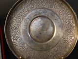 a silver plate that is sitting on a table