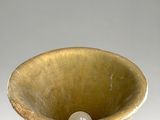 a white vase that has a ball in it
