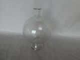 a clear glass vase with a handle on a wooden table