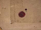a box with a wax seal on it sitting on the floor