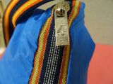 a close up of a zipper on a blue bag
