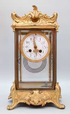 a gold clock that is sitting on a table