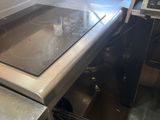 a kitchen with a stove top and a sink in it