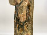 an old wooden statue of a woman holding a baby