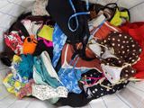 a white basket filled with underwear and a black hat