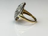 a close up of a gold ring with diamonds on a white surface