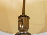 a close up of a lamp with a shade on it