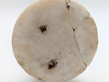 a close up of a piece of marble on a white surface