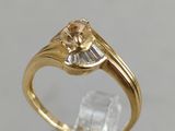 gros plan d'une bague en or surmontée d'un diamant