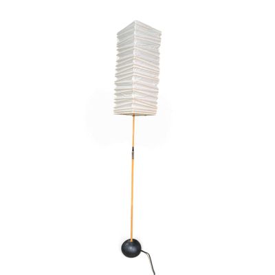 the floor lamp is made of wood and has a white paper shade on it