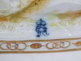 porcelain figurine of a man riding a horse in a landscape