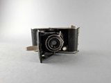 a black camera that is sitting on a white surface