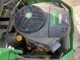 a picture of a green tractor with a fan on it ' s side