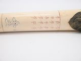 a baseball bat with writing on it sitting on a table