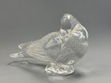 a glass bird that is sitting on top of a table