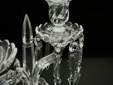 a glass candle holder with a candle inside of it