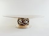 a white table with a glass top and a metal base