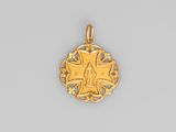a gold pendant with a cross and a star in the center