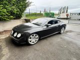 a picture of a black bentley car parked in a parking lot