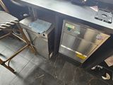 a kitchen with a counter and two stools in it