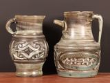 two vases that are sitting on a table