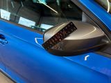 a close up of a car ' s side mirror with a clock on it