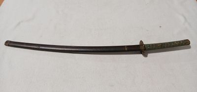 a close up of a knife on a table with a white cloth