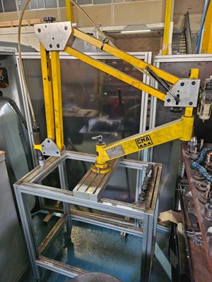 a yellow crane that is sitting in a factory
