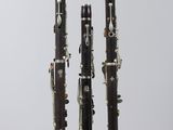 two clarinets sitting on top of each other in front of a white background