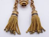 an image of a pair of earrings with tassels hanging from them