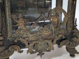 a bronze clock with a woman sitting on a boat