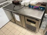 stainless steel counter top in a commercial kitchen with dishes on it