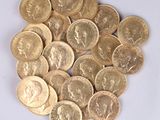 a pile of gold coins sitting on a white surface