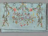 an old blue purse with embroidered flowers and birds on it