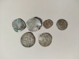 several silver coins sitting on top of a table next to each other