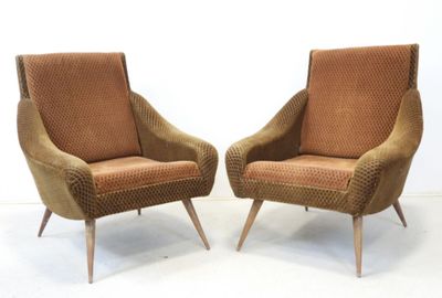 pair of mid century style lounge chairs with upholstered cushions