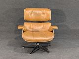 an image of a brown leather office chair on a black metal base