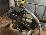 a water pump with a hose attached to it in a room